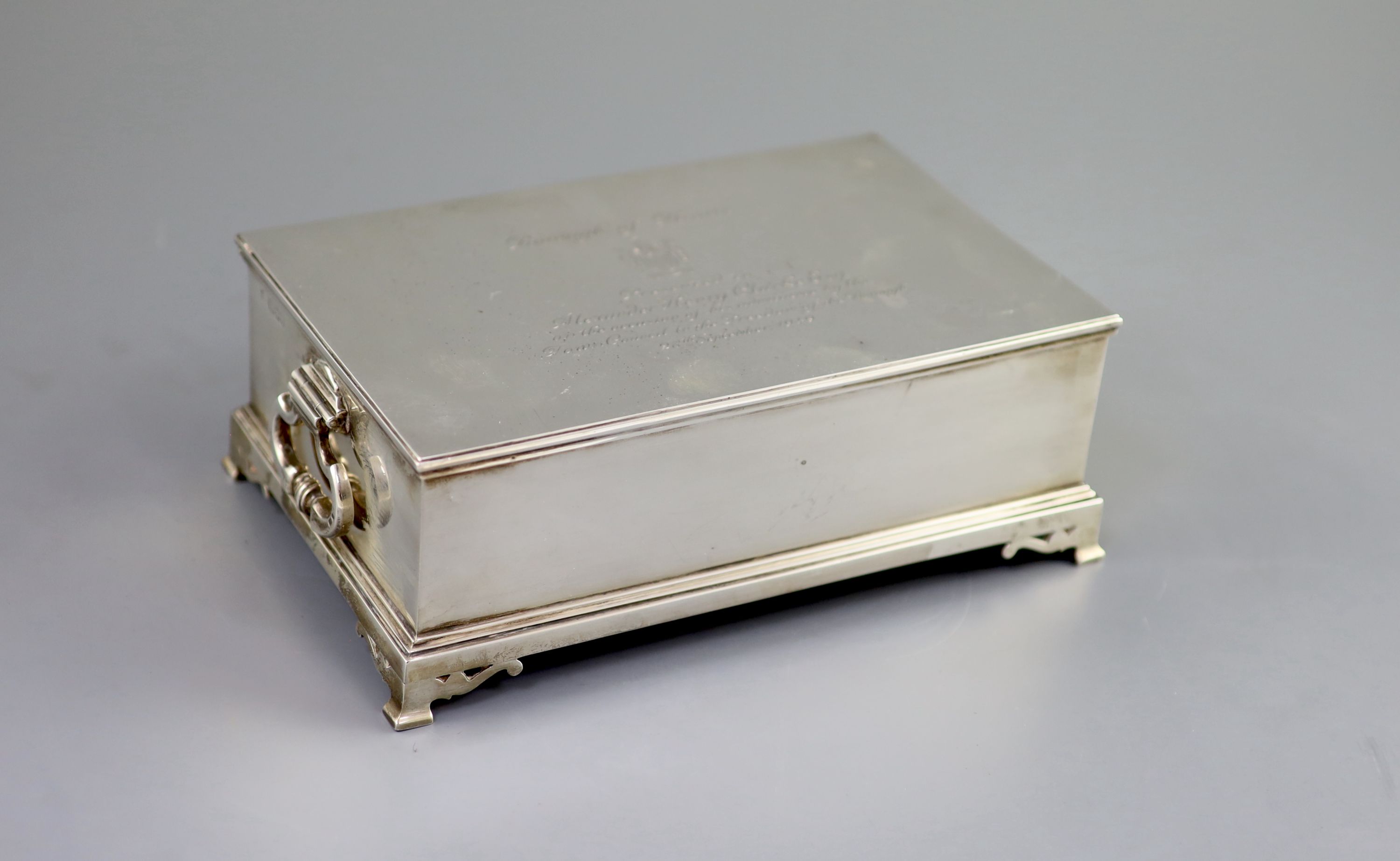 A George VI silver mounted two handled rectangular cigar box, by William Comyns & Sons Ltd, with engraved inscription relating to the Freedom of the Borough of Hove, awarded to Alexander Henry Clarke Esq.